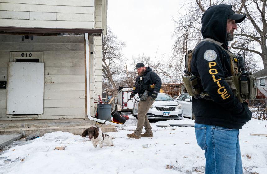Members of the Minnesota Bureau of Criminal Apprehension search for evidence Thursday near where a shooting by federal agents occurred the night prior in Minneapolis.