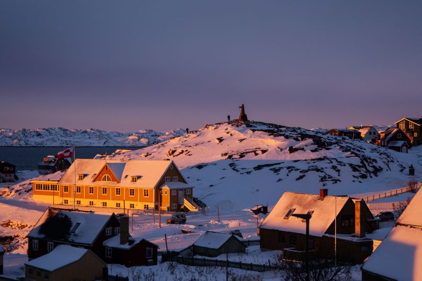A statue on the top of a hill covered by snow at sunset light in Nuuk, Greenland, on January 21, 2026.