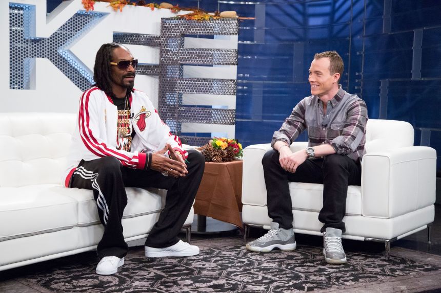 Rapper Snoop Dogg talks with DJ Skee at an event in Los Angeles in 2013.