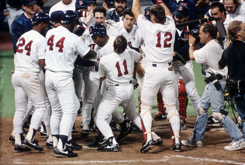 Kirby Puckett is mobbed by his Minnesota Twins teammates after hitting a walkoff home run in Game 6 of the World Series in 1991.