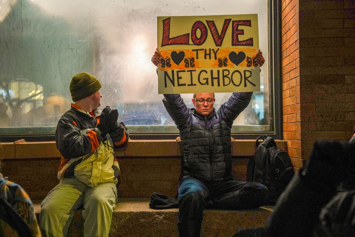 A demonstrator in downtown Minneapolis holds up a sign January 9 that reads, 