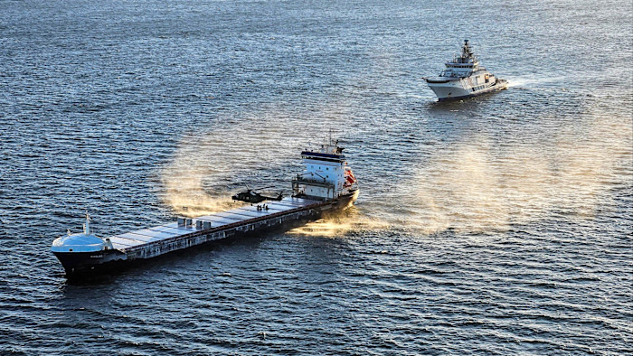 A Finnish Border Guard helicopter lands on the cargo ship Fitburg as a Finnish coast guard patrol ship approaches during the vessel’s seizure in the Gulf of Finland last week.