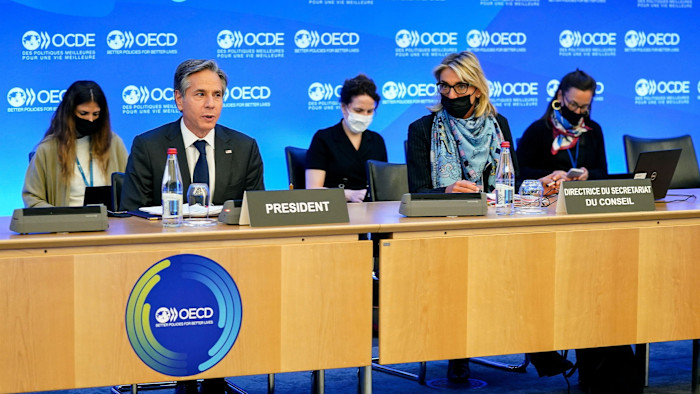Antony Blinken, then US secretary of state, sits next to OECD official Silvia da Rin Pagnetto at a table during an OECD ministerial council meeting in Paris in 2021.