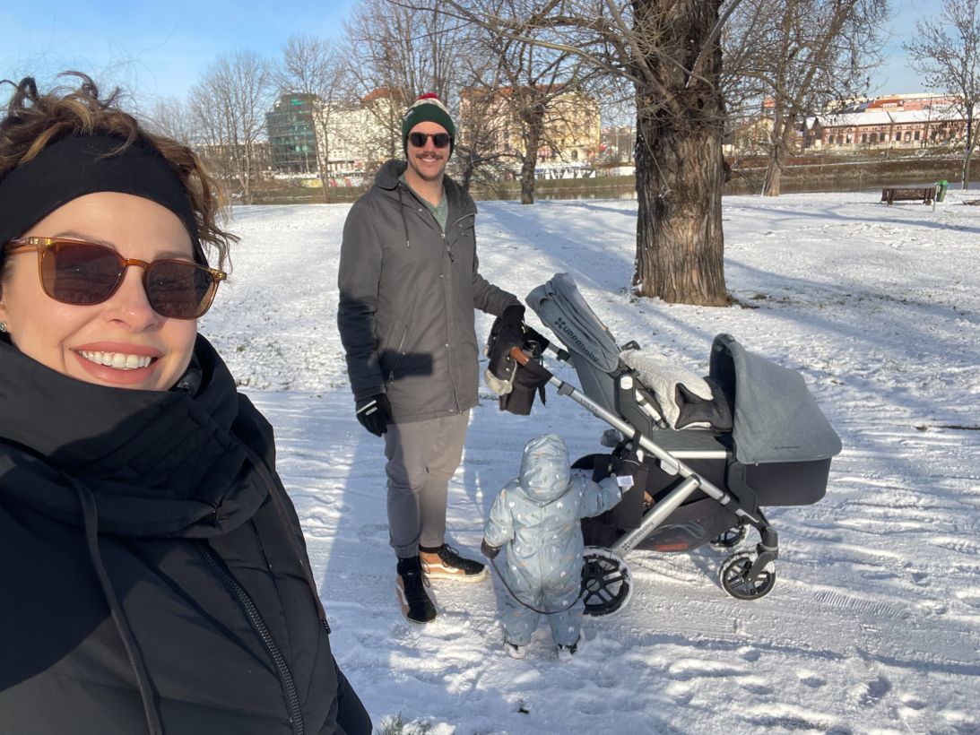 The family take a walk in Prague on a snowy day.