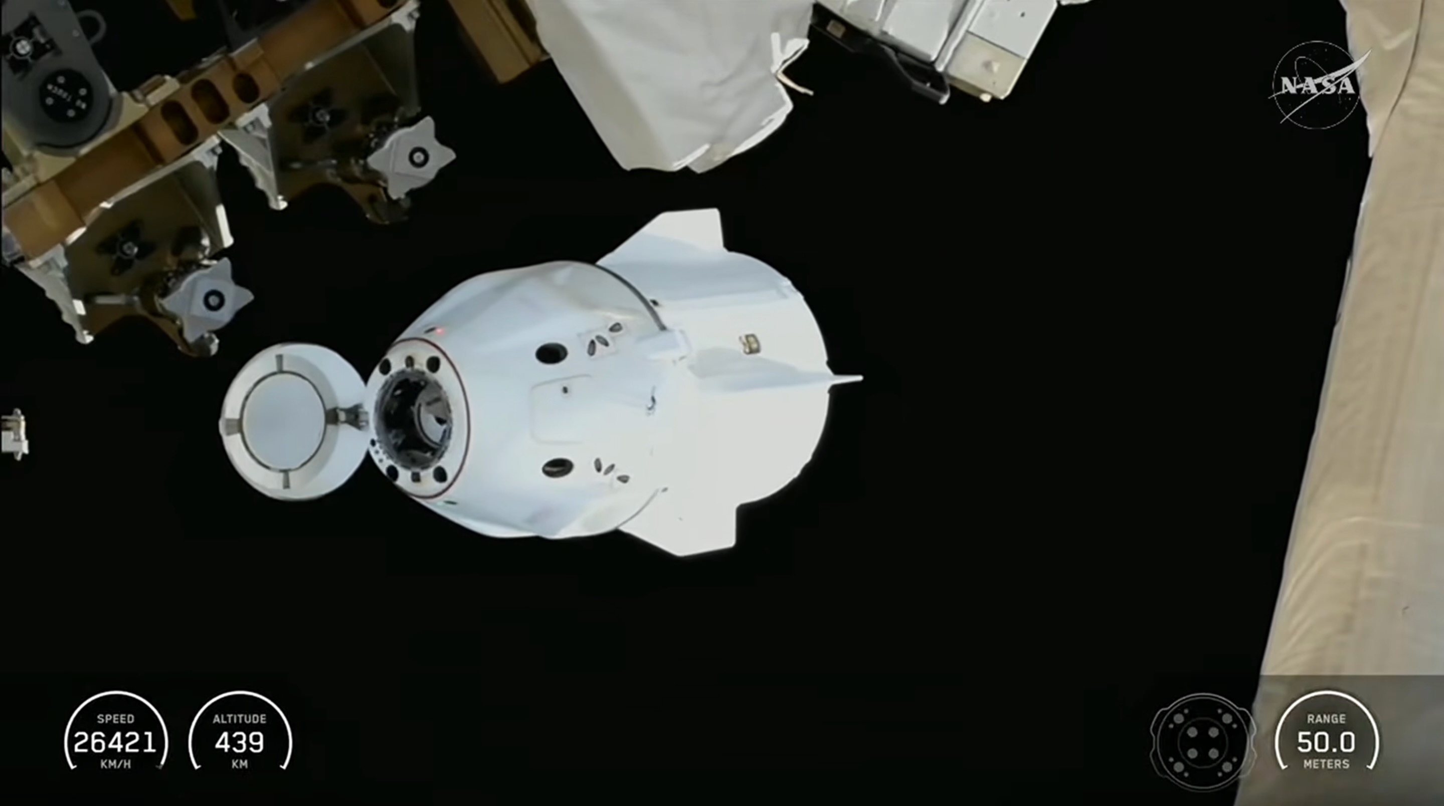 a white conical space capsule is seen near a larger space station