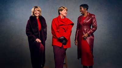 Hazel Irvine, Clare Balding and Jeanette Kwakye stand together smiling and laughing, all wearing outfits in different shades of red and burgundy