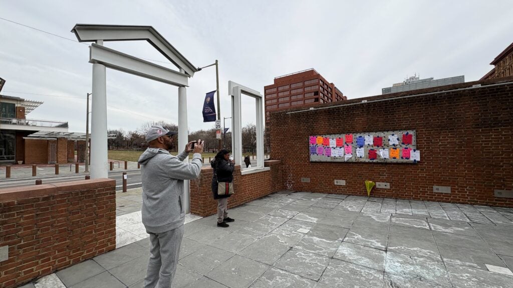 Handwritten signs reading "learn all history" attached at the President's House exhibit