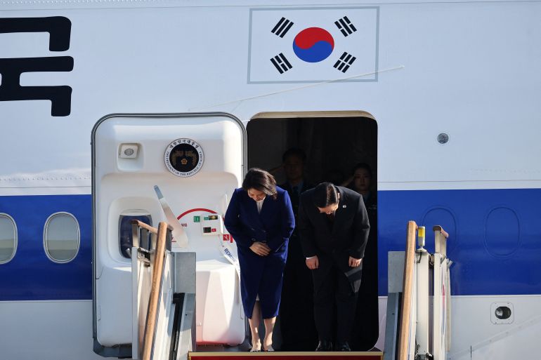 South Korean President Lee Jae Myung and his wife Kim Hye-kyung bow at Seoul Air base as they leave for Beijing, in Seongnam, South Korea, January 4, 2026. REUTERS/Kim Hong-Ji