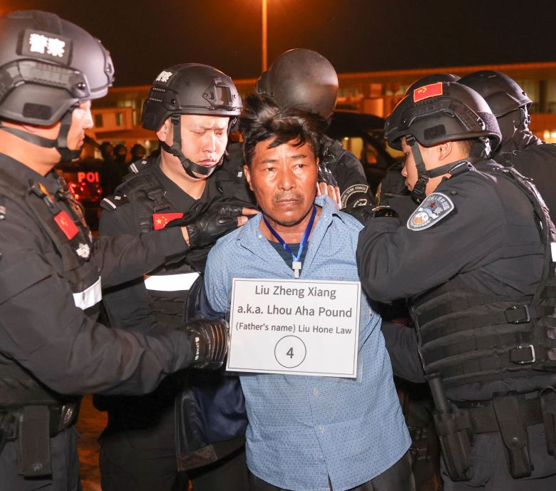 Liu Zheng Xiang is handed over to Chinese police officers at the Nay Pyi Taw International Airport in Nay Pyi Taw, Myanmar, on January 30, 2024.