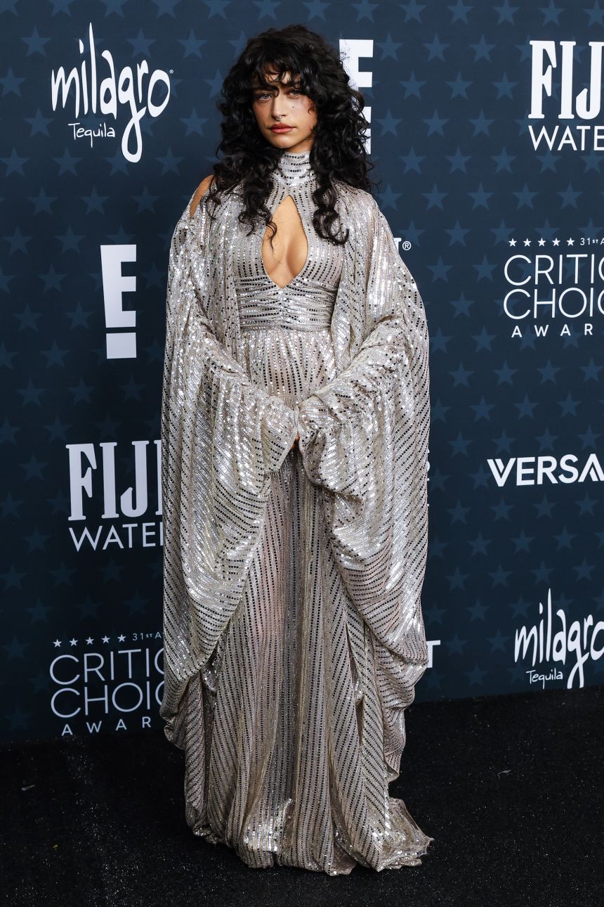 On a night of muted colors and understated styling, “Marty Supreme” star Odessa A’zion broke the mold in a sparkling, maximalist gown by OTT.