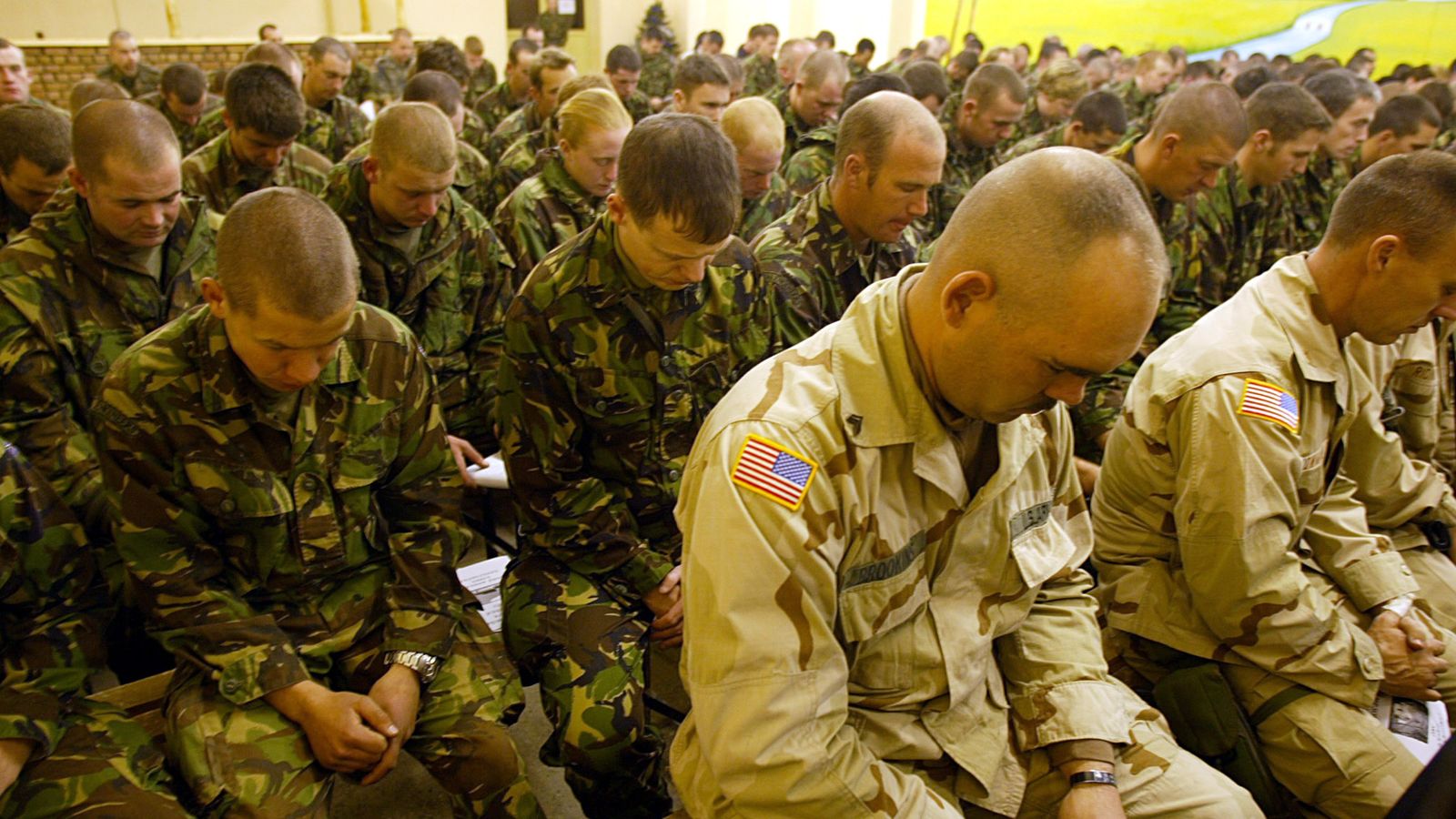 British and US soldiers hold a minute silence in Afghanistan in 2002. Pic: Reuters