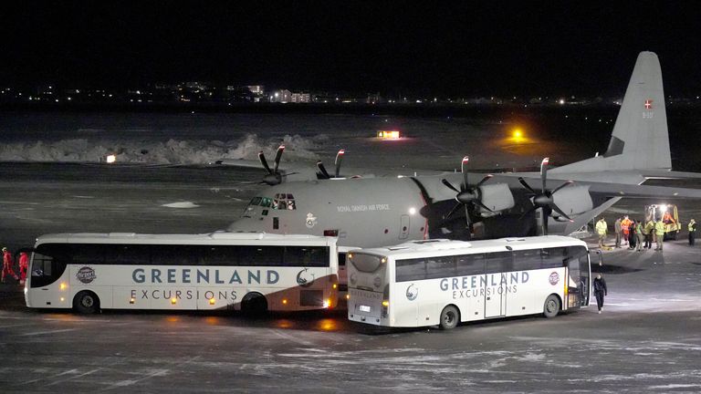 A Royal Danish Air Force plane carrying personnel in military fatigues lands at Nuuk airport Greenland.
Pic: Reuters