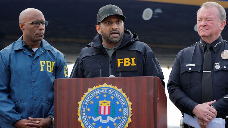 FBI Director Kash Patel (c) announces Wedding's arrest. Pic: Reuters