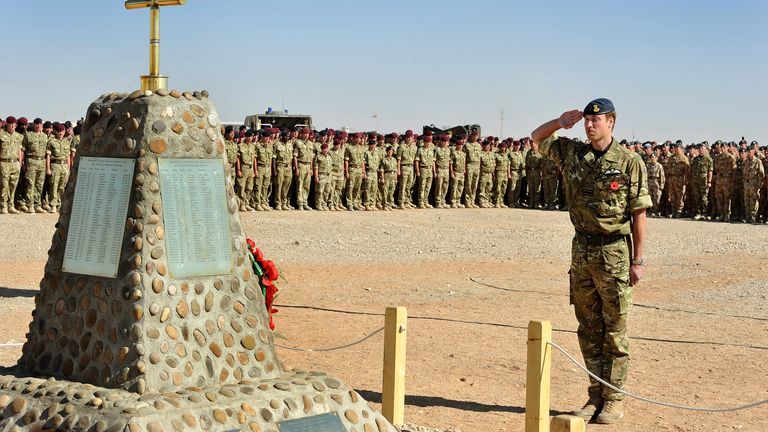 Prince William salutes in front of the memorial to the British soldiers killed in Afghanistan