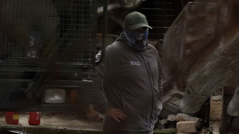 A masked man was seen on site as the demolition got under way