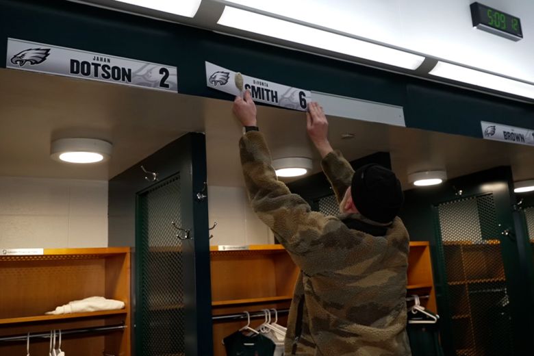 Jason Arnold swaps in a nameplate in the Philadelphia Eagles locker room after a game in December.