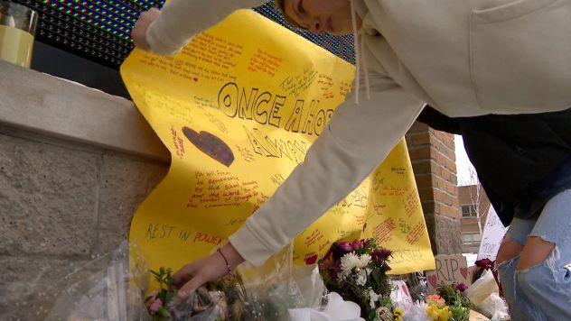 Students at Preble High School place a memorial banner honoring Alex Pretti, who was shot and killed by federal agents in Minnesota last week.