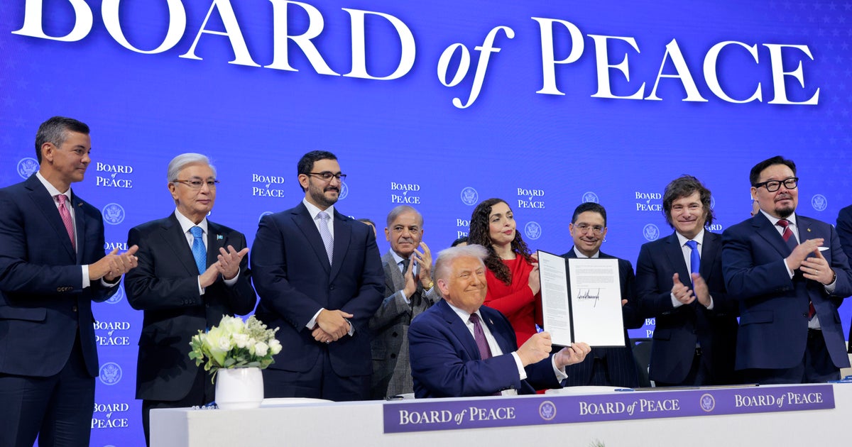 Trump and "Board of Peace" partners sign founding charter in Davos, as he pledges group will work with U.N.