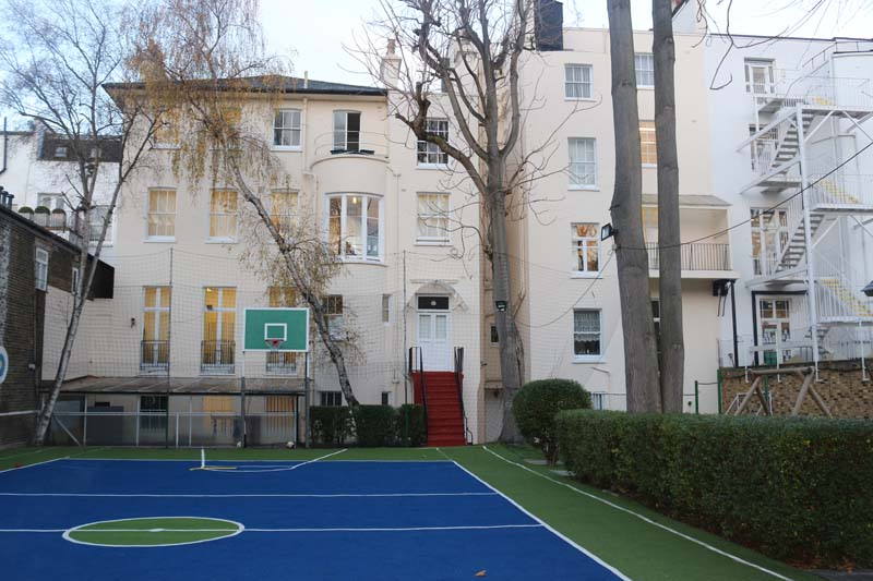 The School at the Russian Embassy in the UK, a large white building with an outdoor basketball court.