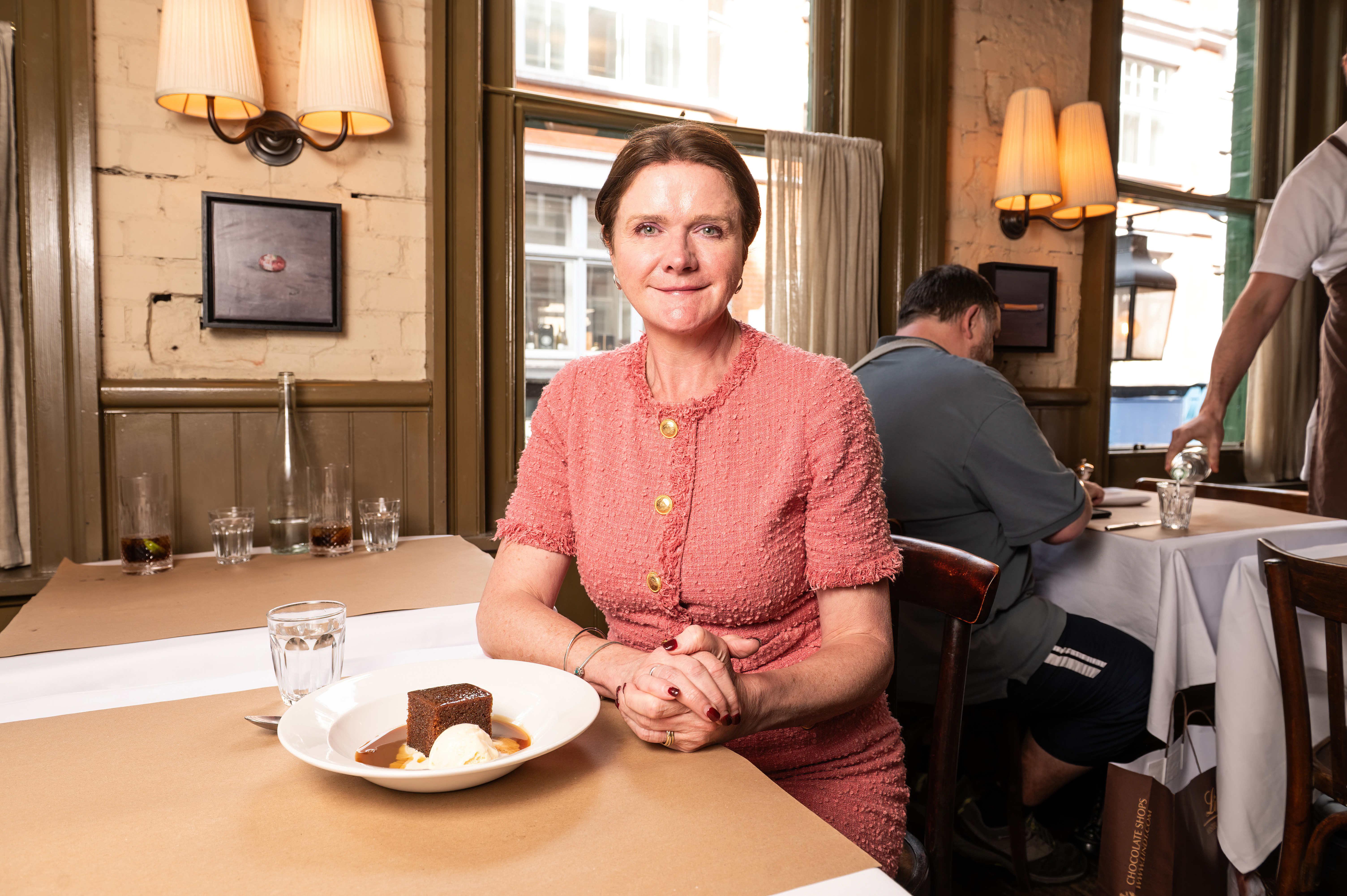 Kate Nicholls, Chief Executive of UK Hospitality, seated at a restaurant table with dessert.