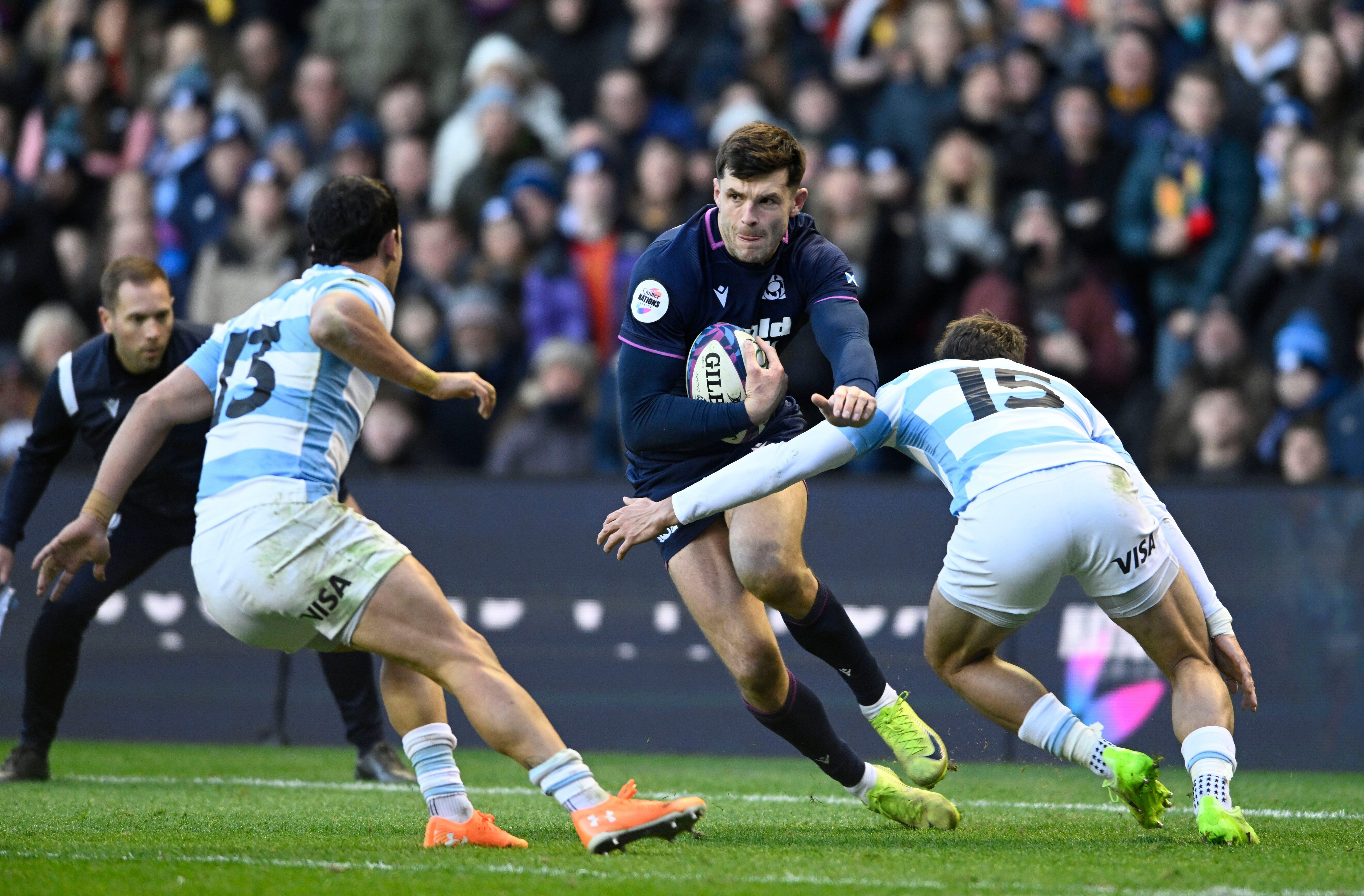 Matias Moroni of Argentina, Blair Kinghorn of Scotland, and Juan Cruz Mallia of Argentina in action during a rugby match.
