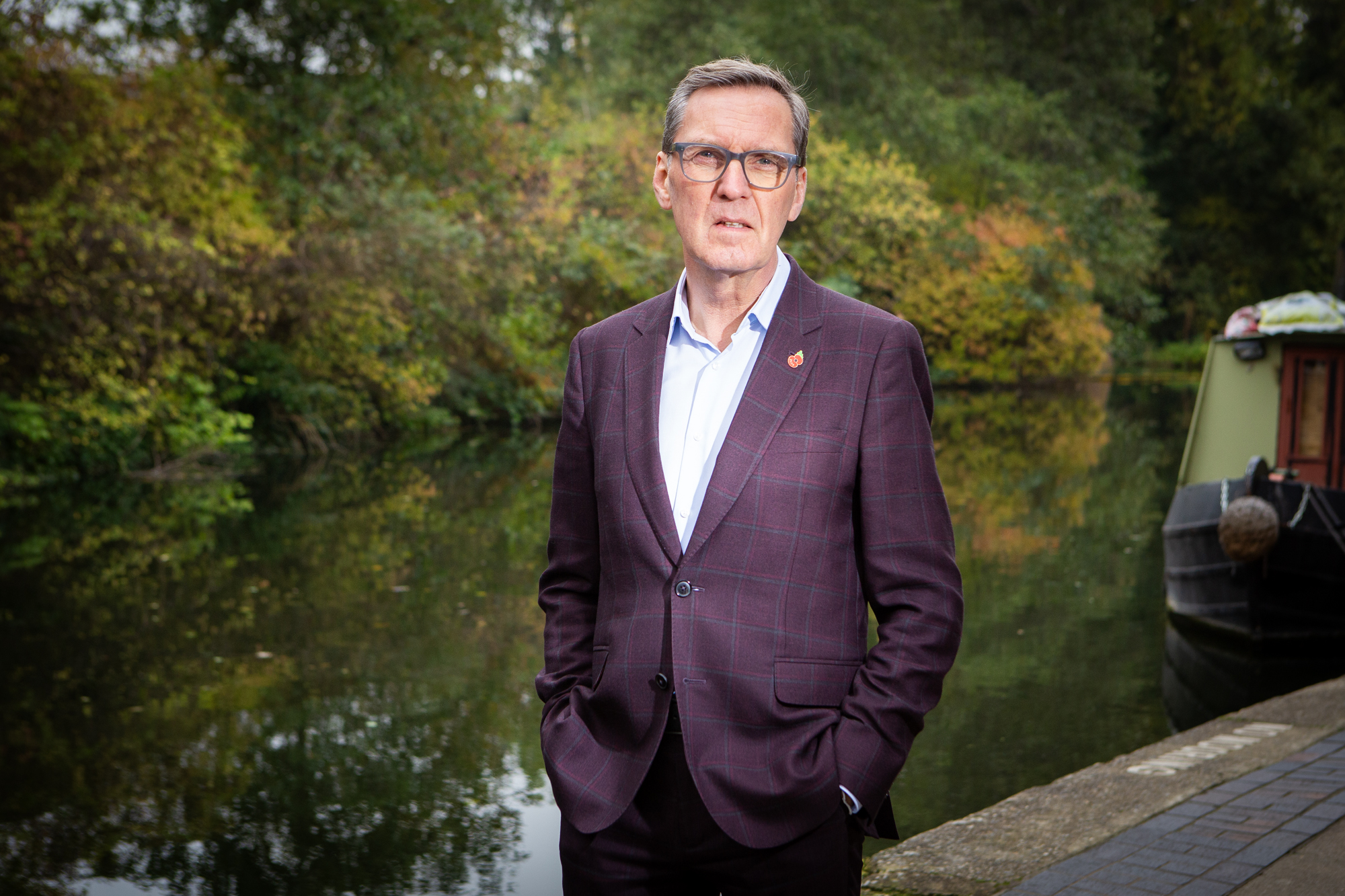 Former health secretary Alan Milburn wearing a plaid jacket, standing by a canal near King's Cross.