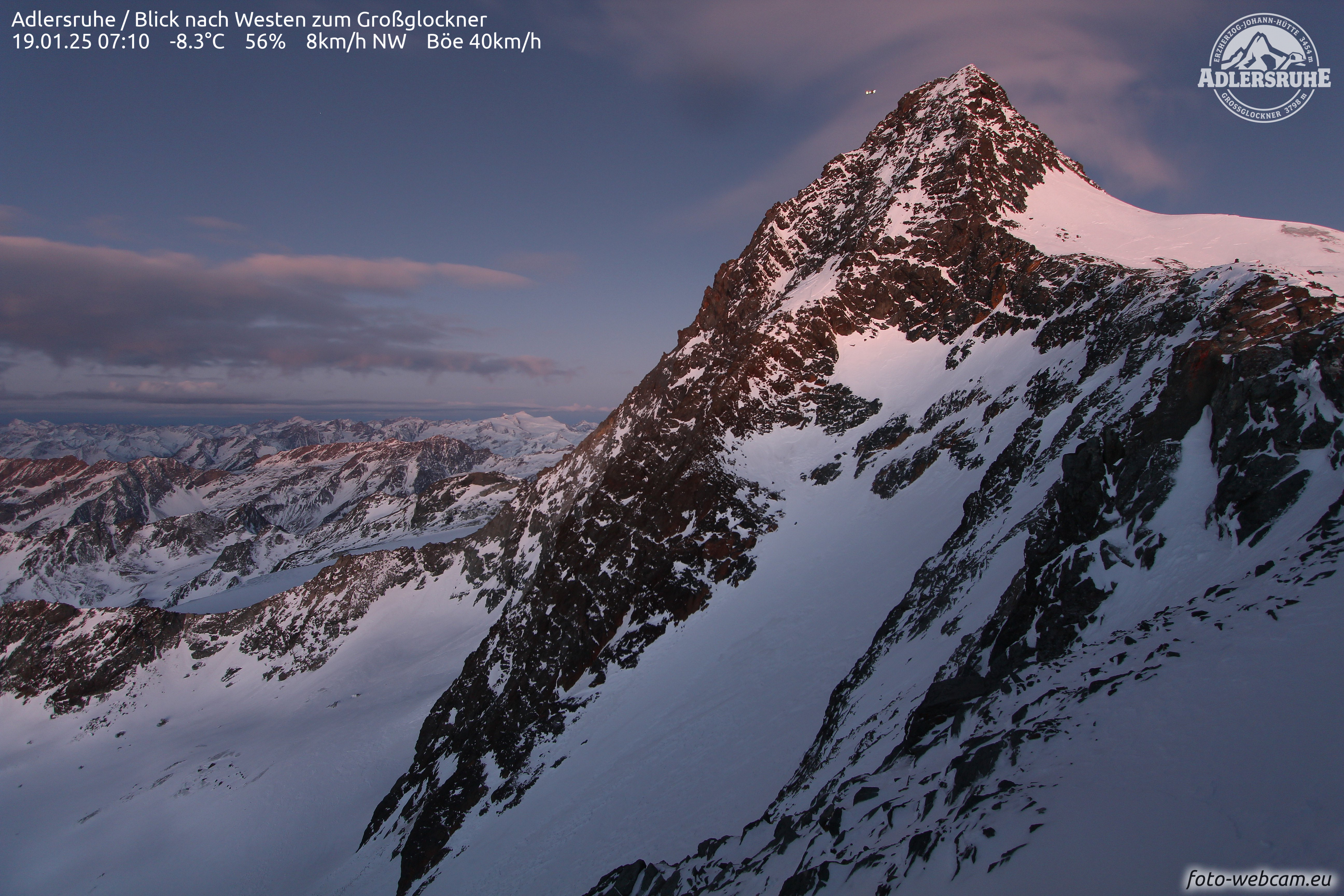 Webcam footage shows a helicopter above snow-covered mountains.