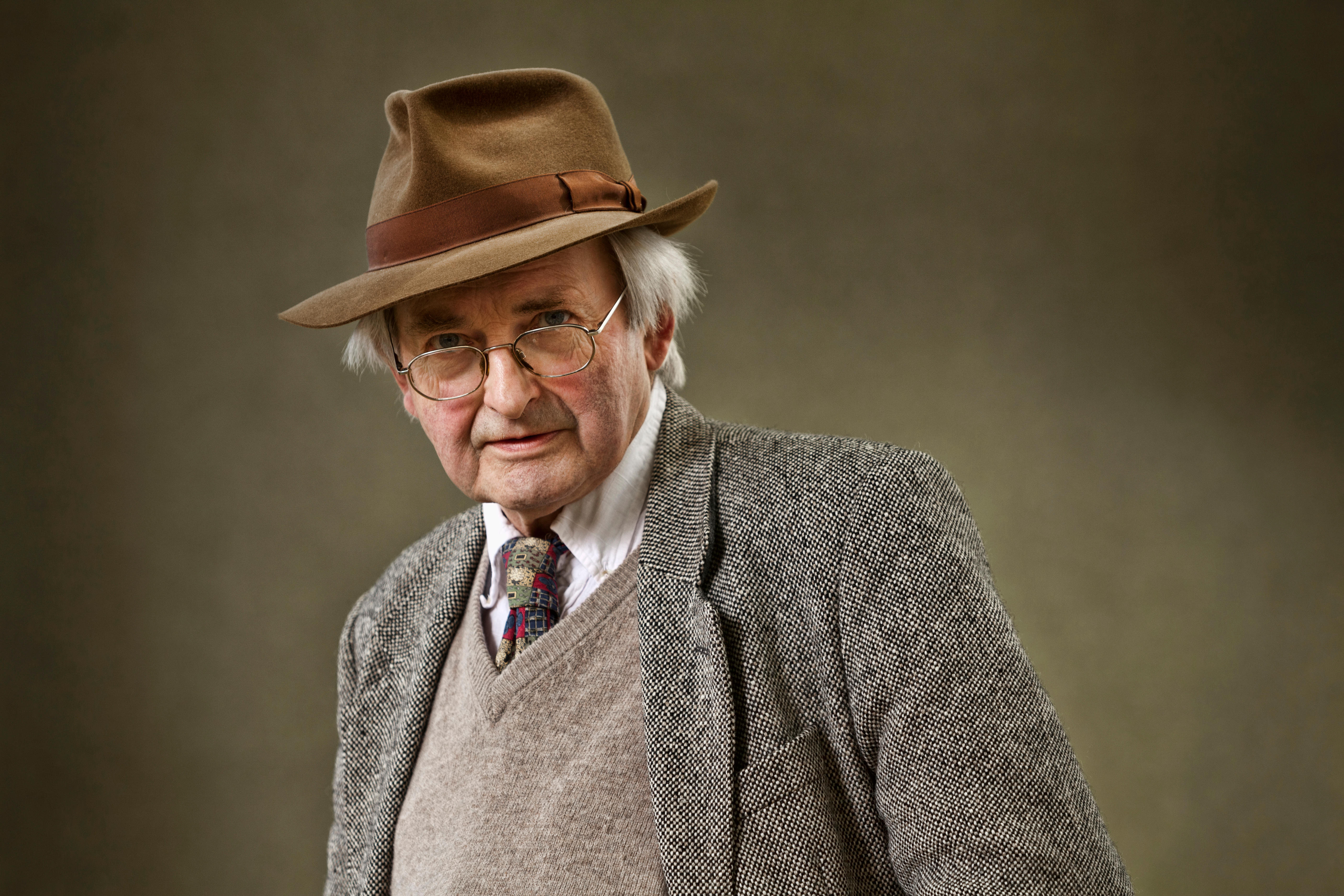 Allan Massie, Scottish journalist, columnist, sports writer, and novelist, wearing a fedora, glasses, and a tweed jacket.