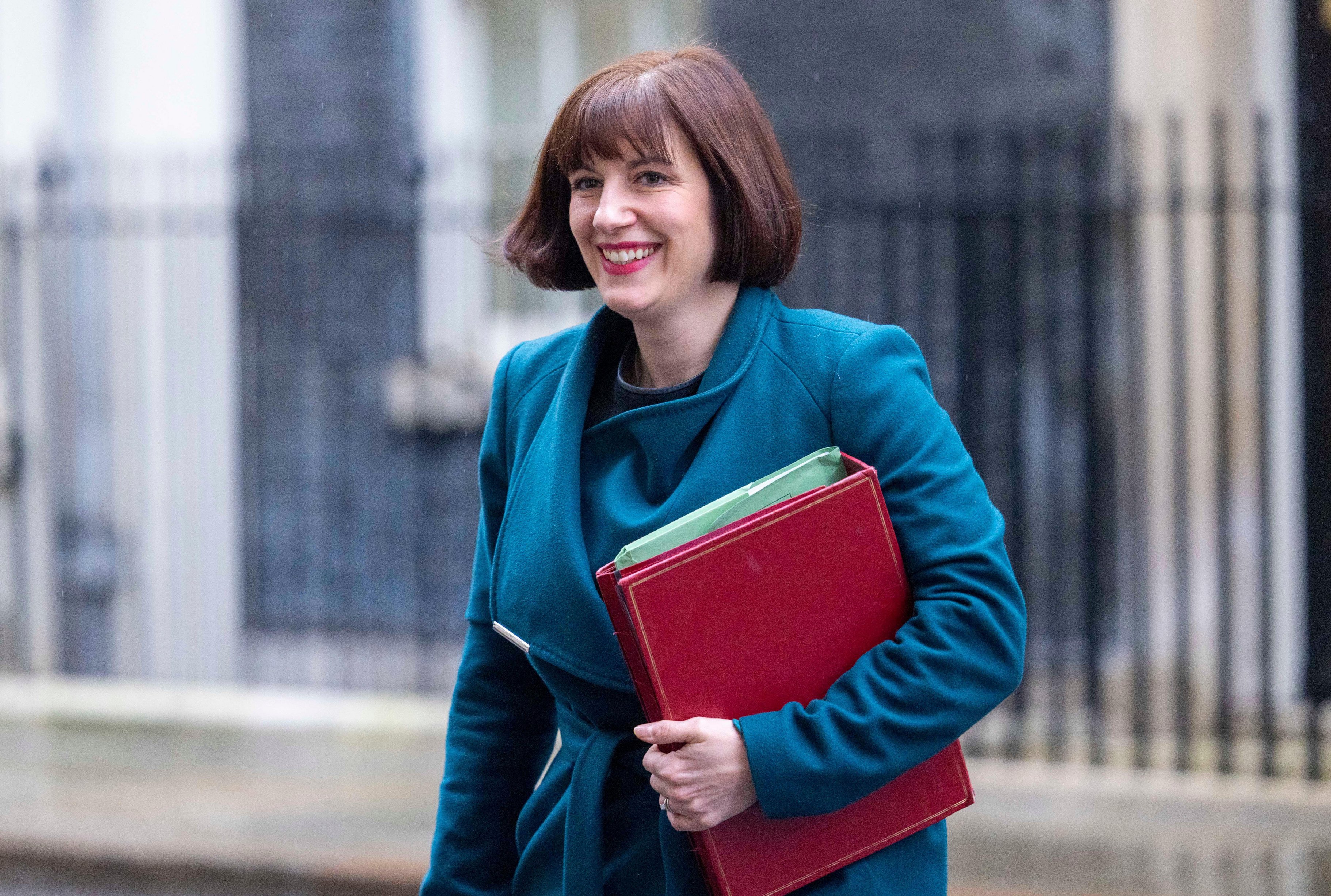 Bridget Phillipson, Education Secretary, smiling while carrying a red folder in Downing Street.