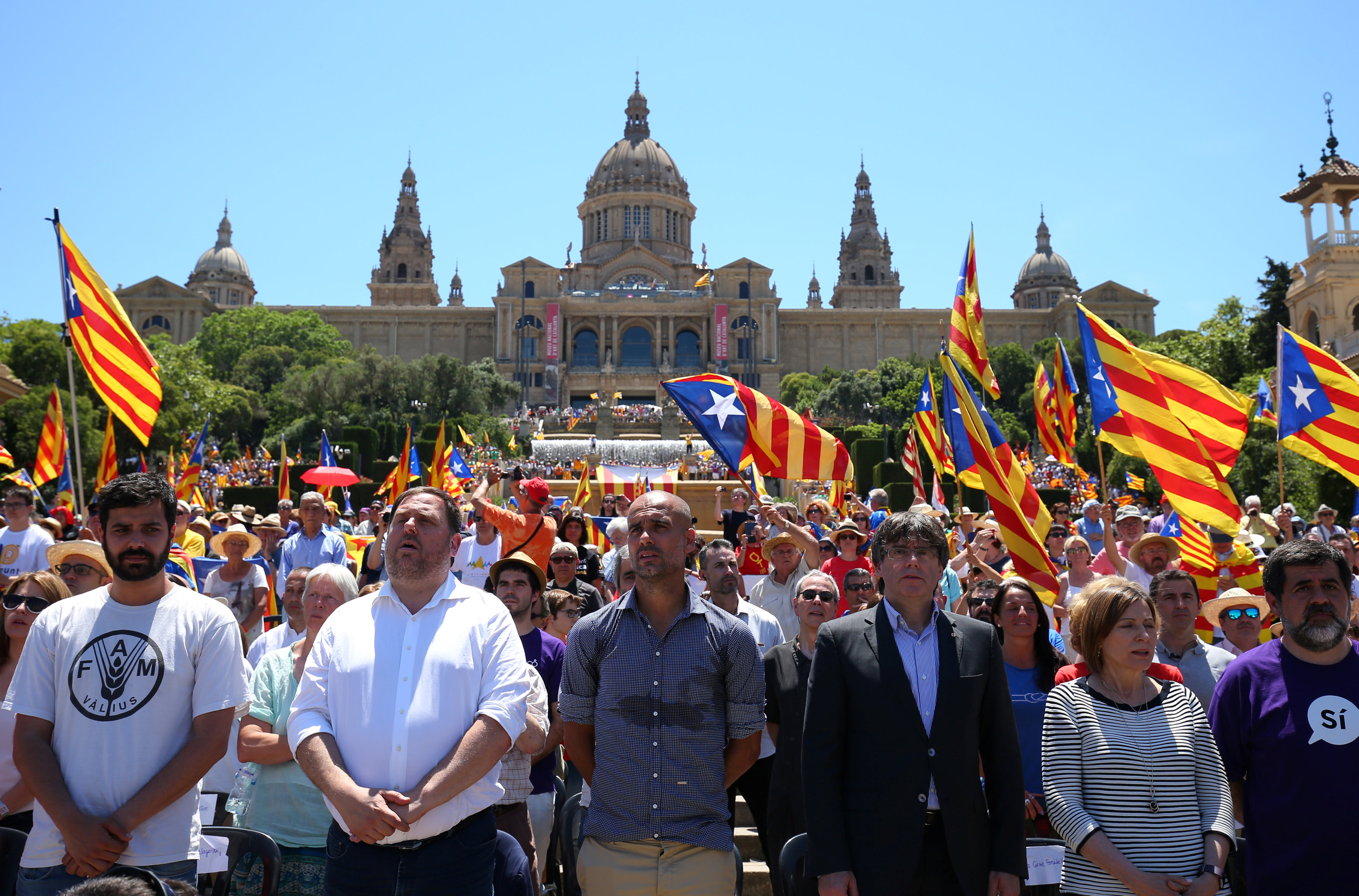 Manchester City's manager Pep Guardiola and Catalan Regional President Carles Puigdemont takes part in a pro-independence rally in Barcelona