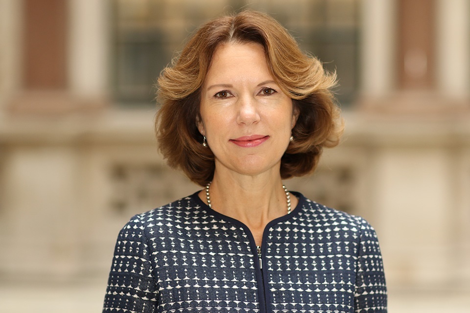 Caroline Wilson, Ambassador to China, wearing a navy blue patterned jacket and a pearl necklace.