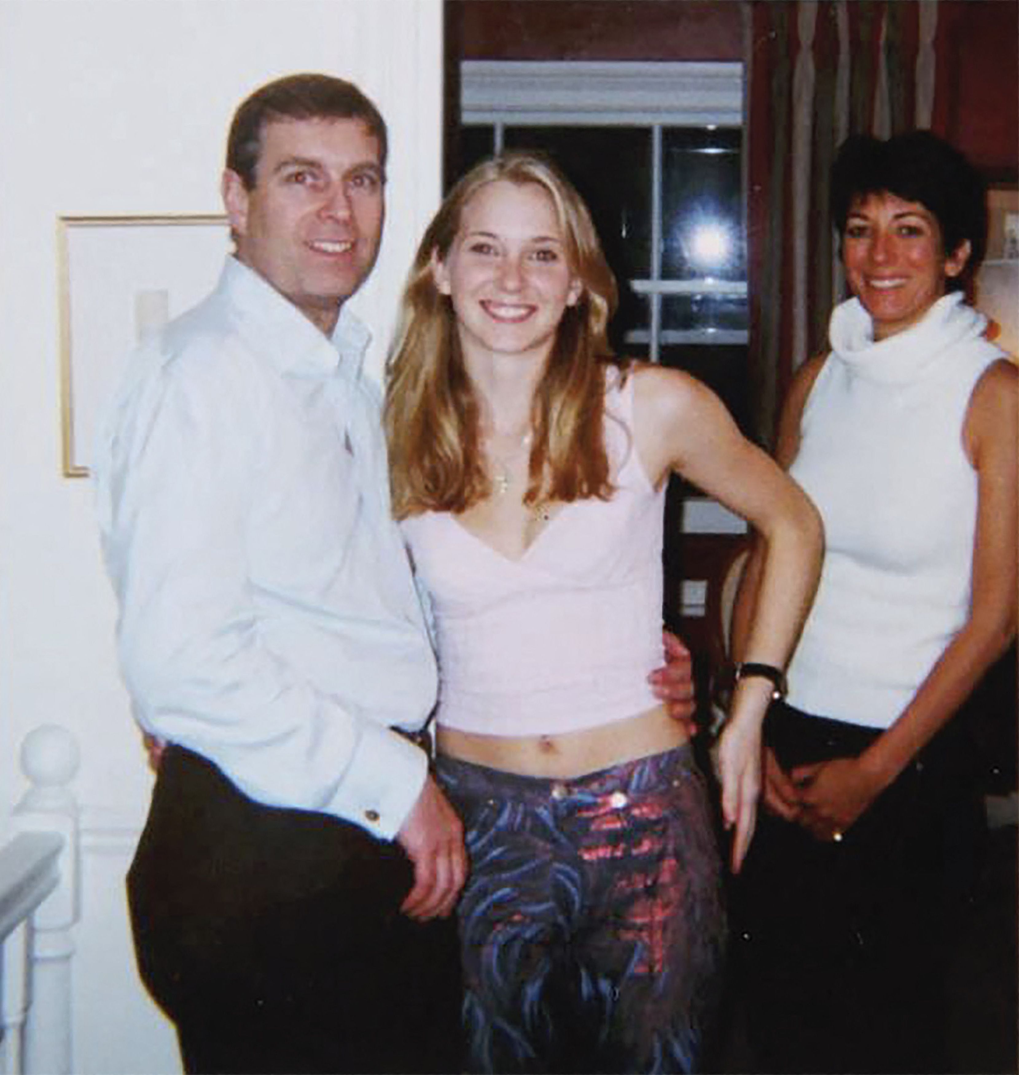 Prince Andrew with his arm around Virginia Giuffre's waist, and Ghislaine Maxwell standing next to them.
