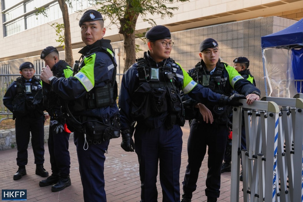 Police outside the West Kowloon Law Courts Building on February 9, 2026, ahead of the sentencing of pro-democracy media tycoon Jimmy Lai. Photo: Kyle Lam/HKFP.