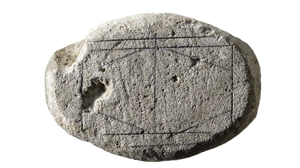 Ancient carved stone with geometric patterns for ancient Roman game