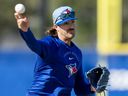Toronto Blue Jays pitcher Kevin Gausman makes a throw to first base during a drill at Spring Training.