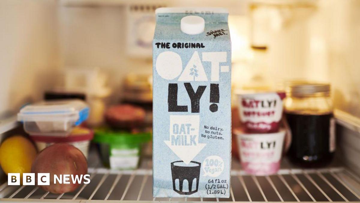 A carton of Oatly in a fridge.