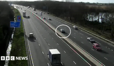 The Nissan Micra circled in white as other vehicles pass on either side of the motorway.