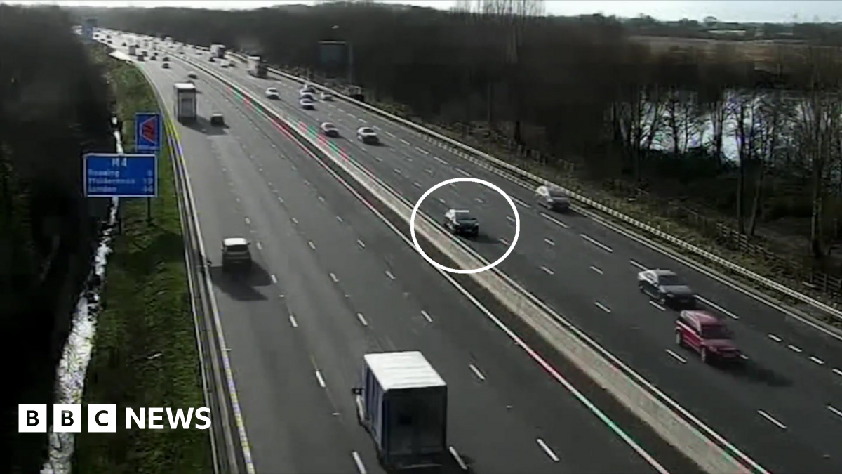 The Nissan Micra circled in white as other vehicles pass on either side of the motorway.