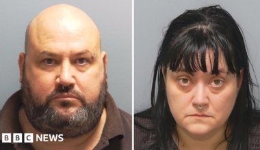 Custody photos of Richard Elkin and Hayley Bell. He is bald with a greying beard and a ring through his nose. She has black hair over her shoulders, a fringe and also has a ring through her nose.