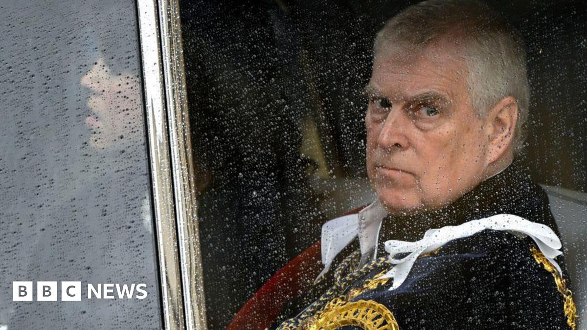 Andrew Mountbatten-Windsor seen through a carriage window - he is wearing ceremonial uniform. His daughter Eugenie can just be seen sitting alongside him