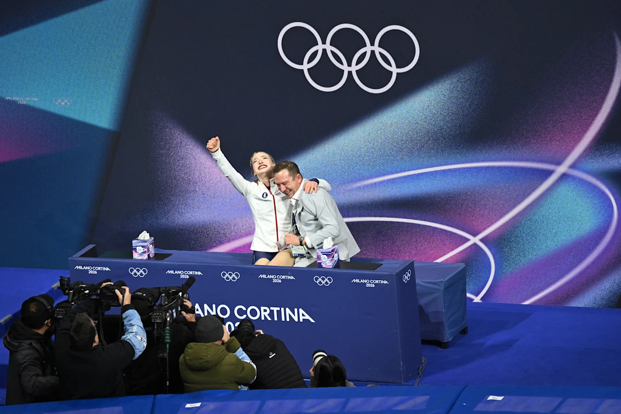 USA's Amber Glenn (L) reacts in the kiss and cry area after competing in the figure skating women's single free skating final during the Milano Cortina 2026 Winter Olympic Games at Milano Ice Skating Arena in Milan on February 19, 2026. (Photo by Antonin THUILLIER / AFP via Getty Images)