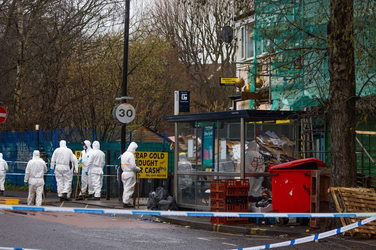 Police and forensic officers searching outside Maliks store, on Stapleton Road 