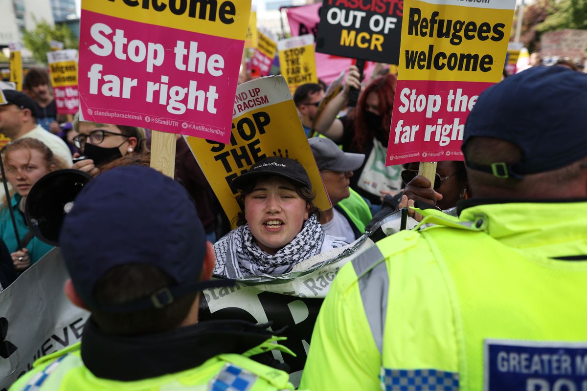 Police form a line in front of counter-protestors from Stand Up to Racism at the Britain First March For Remigration on August 2, 2025 in Manchester, England. 