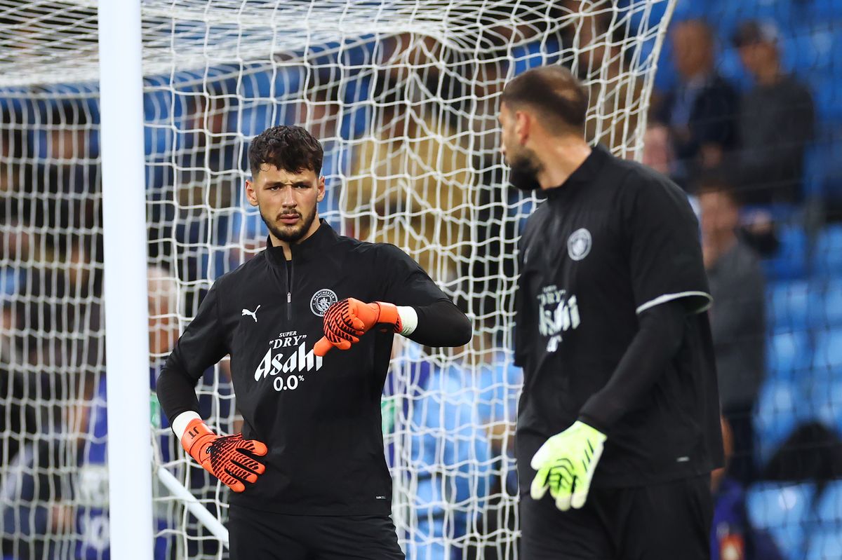 James Trafford of Manchester City speaks to teammate Gianluigi Donnarumma during the warm up prior to the UEFA Champions League 2025/26 League Phase MD1 match between City and SSC Napoli
