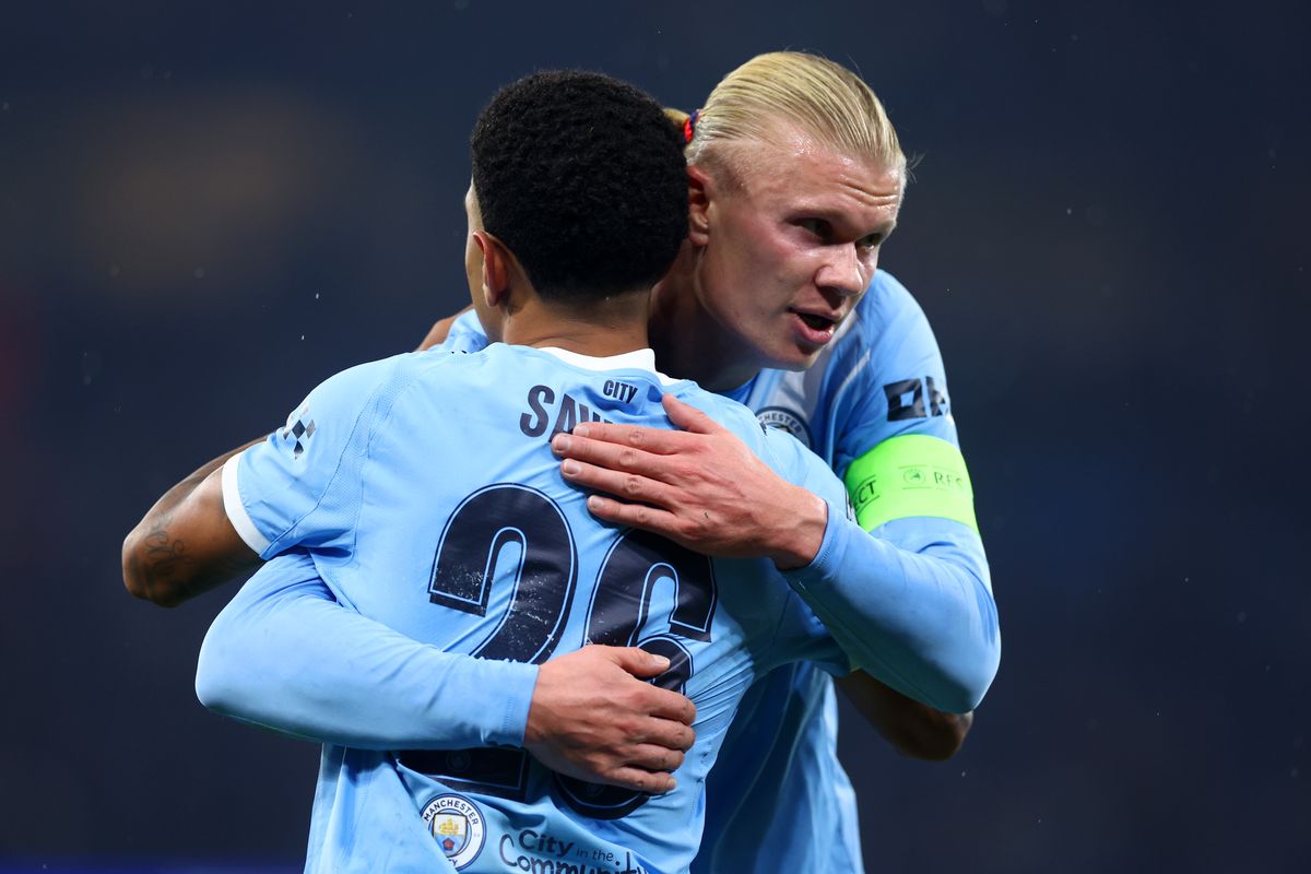 Erling Haaland and Savinho embrace during Manchester City's clash with Borussia Dortmund in the Champions League