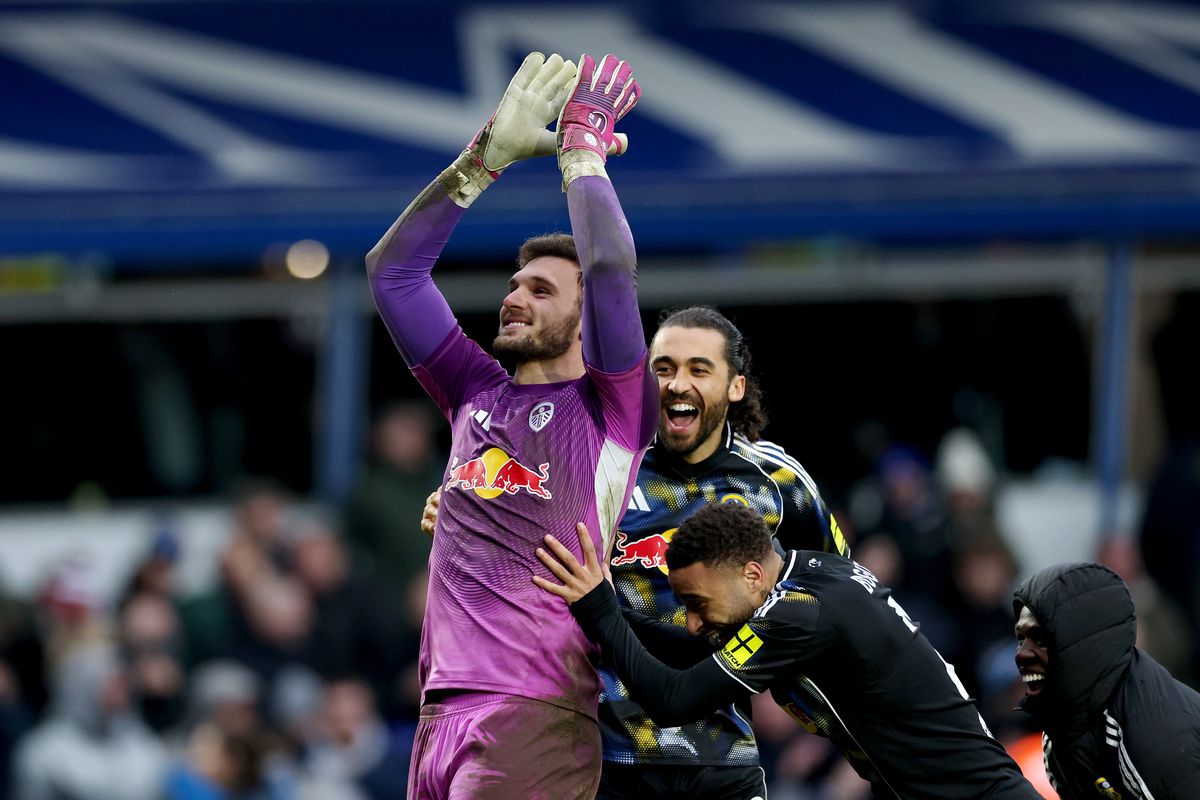 Leeds United teammates push Lucas Perri towards the away end