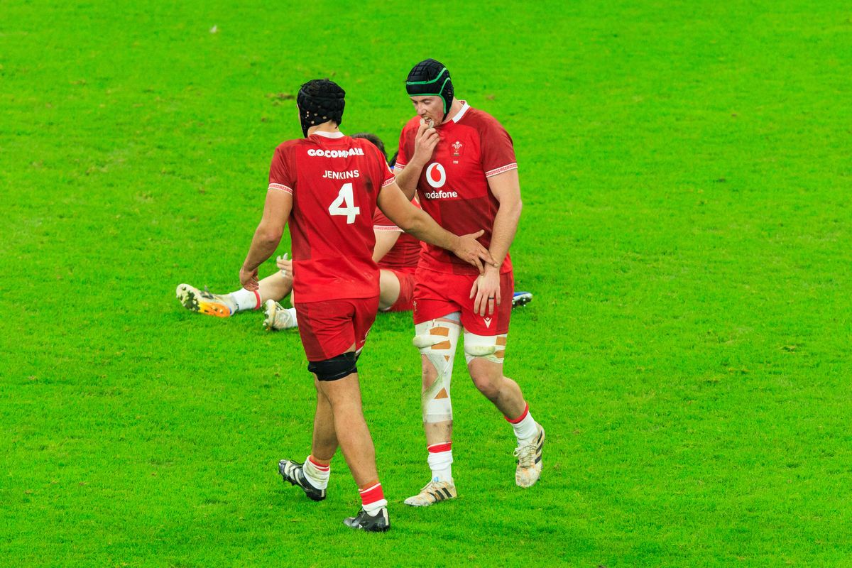 Dafydd Jenkins of Wales commiserates with Adam Beard after his attempted kick led to a try by France