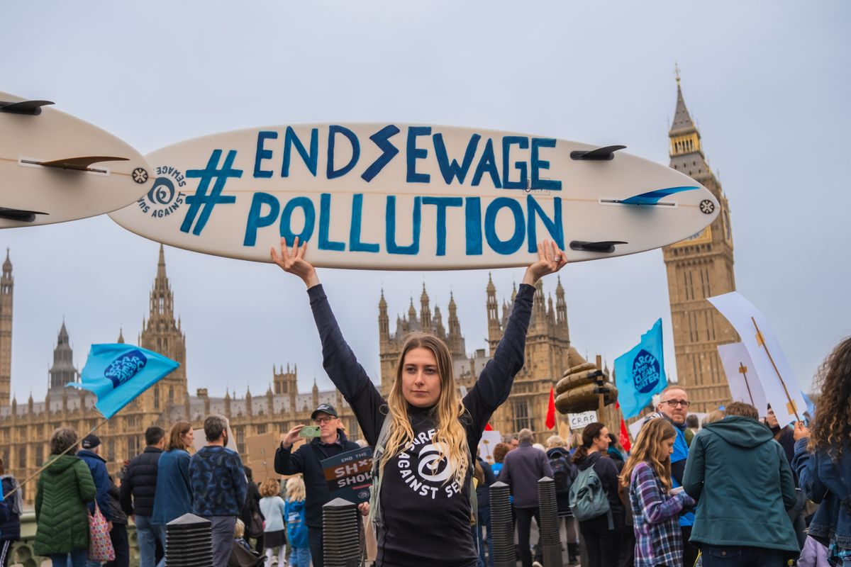 Anti sewage pollution campaigners outside the Houses of Parliament in London