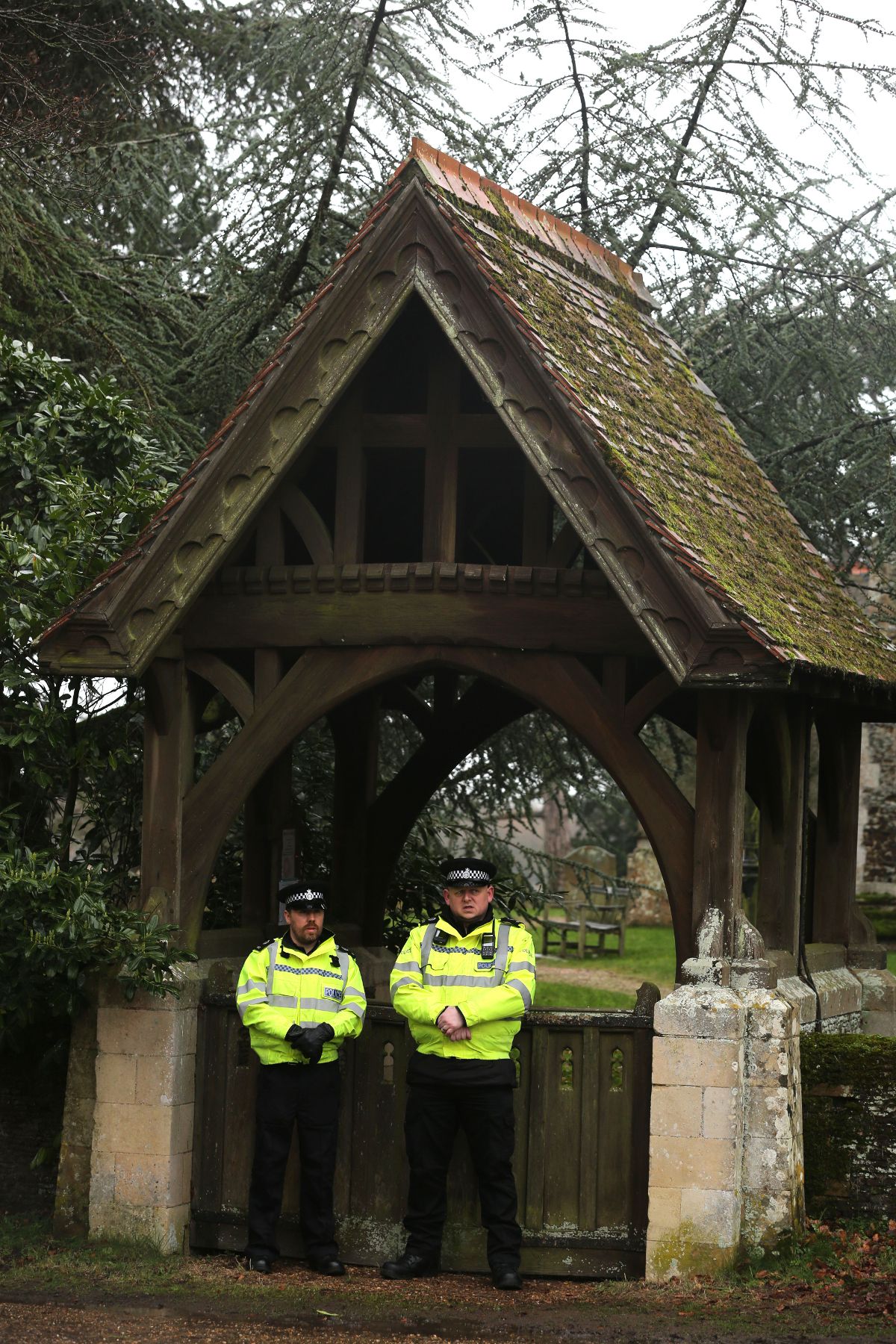 Police officers block access to the church graveyard on February 21, 2026 in Sandringham, England