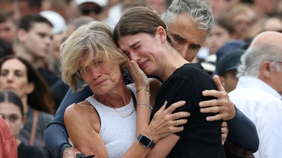 A woman pays her respects at Bondi Pavilion to victims of a shooting during a Jewish holiday celebration at Bondi Beach, in Sydney, Australia, December 15, 2025. - Hollie Adams/Reuters